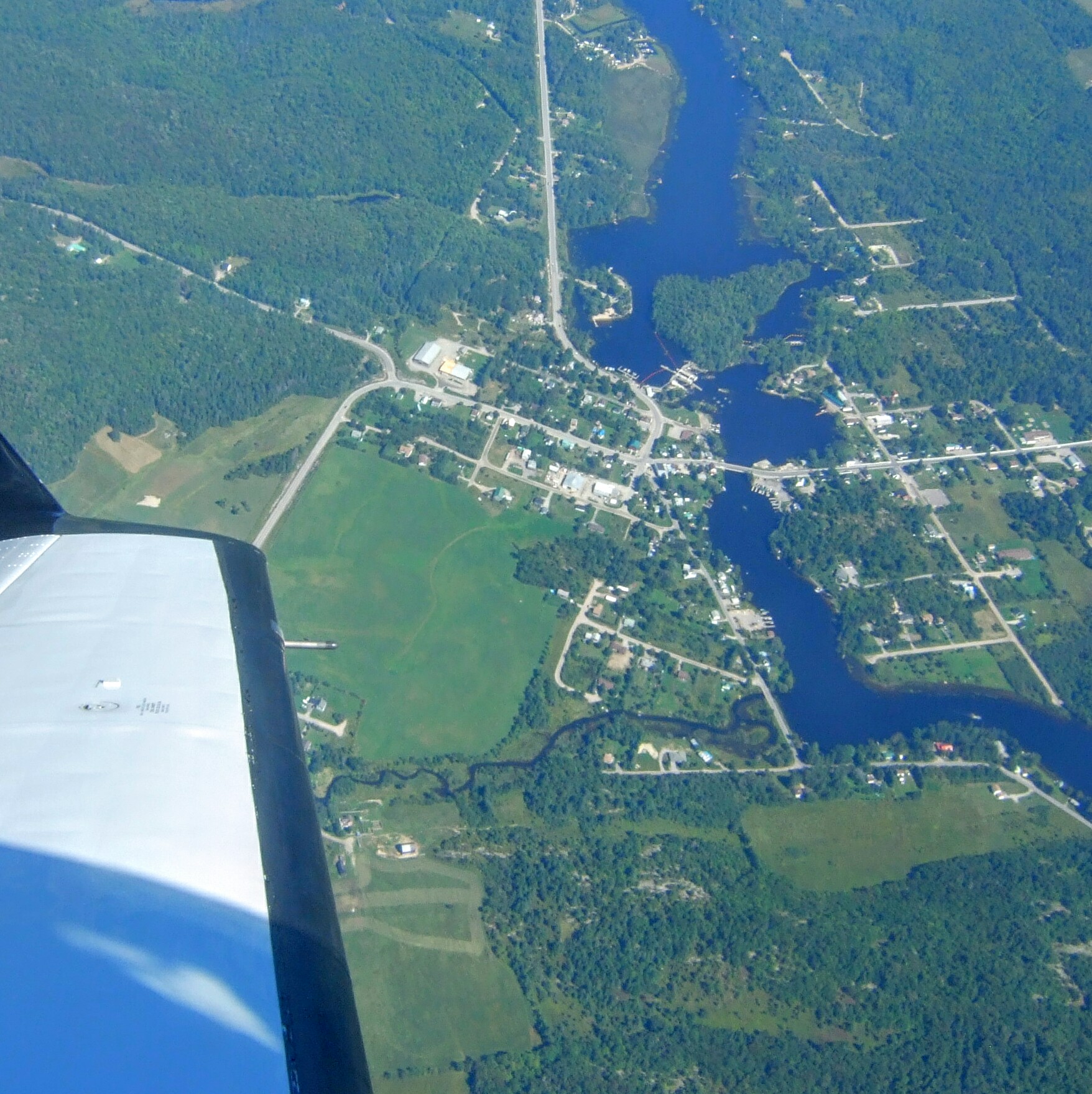 Arial View from an airplane that include a lake and town